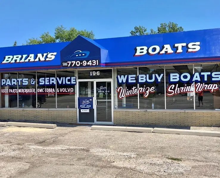 Exterior of a blue boat sales and service shop.